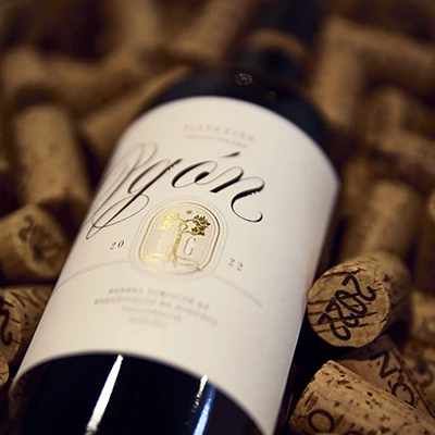 Botella de vino Ogón 2022 entre corchos de bodega
